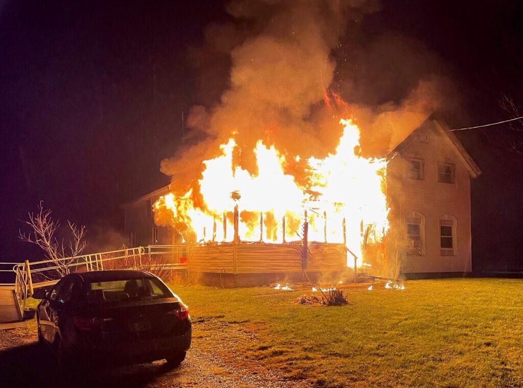 A burning house at night
