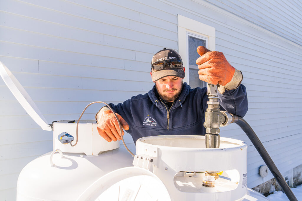Colby & Gale driver Carter Frost safely filling a residential propane tank during a Fuel Your Love delivery in Boothbay.