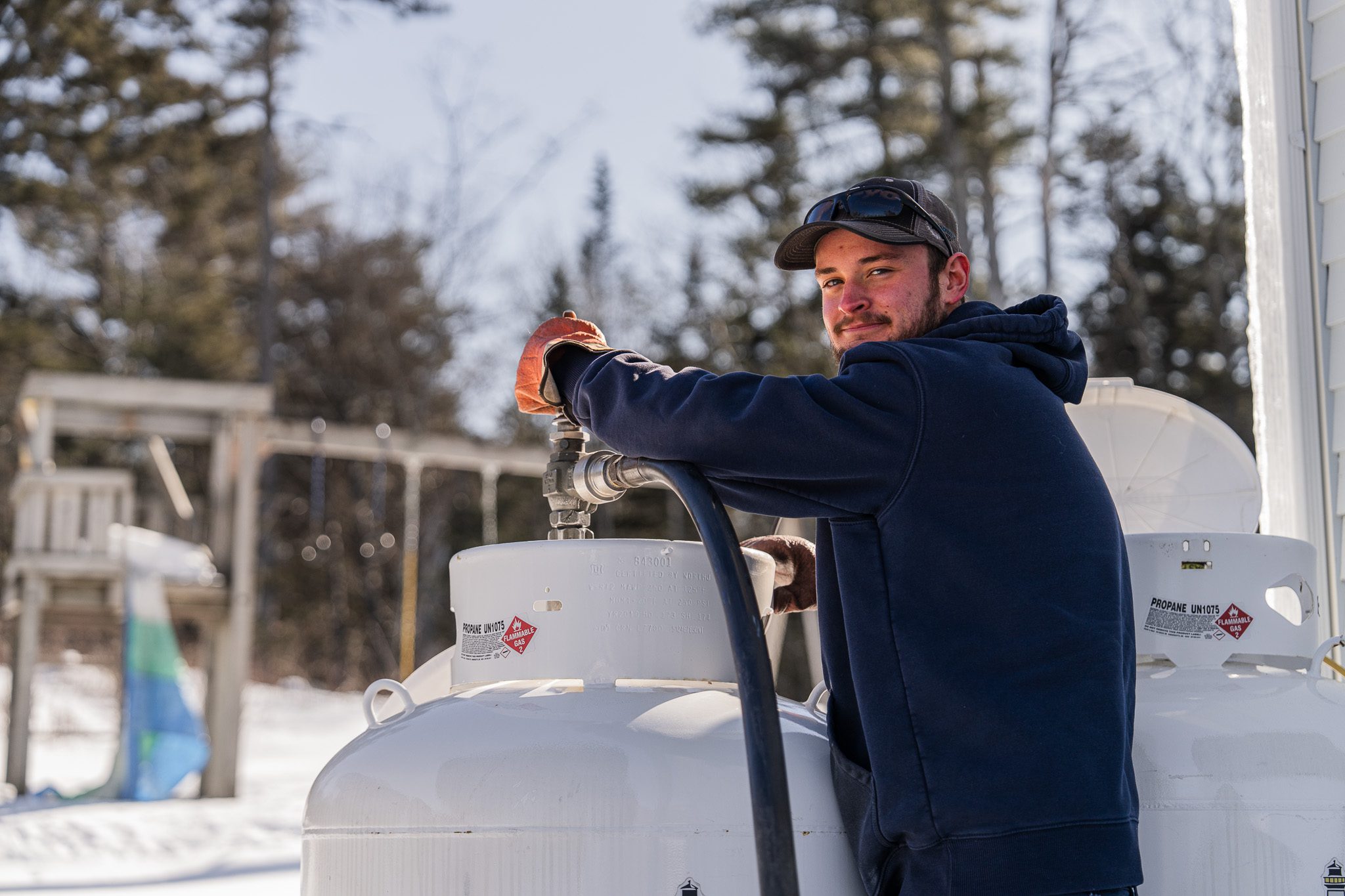 Propane driver Carter Frost filling up customers tank in Boothbay.