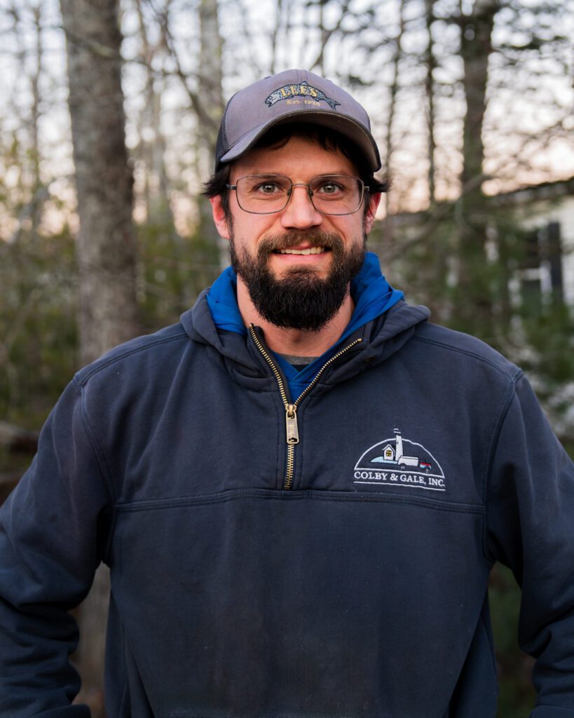 Cody Barter, wearing hat and glasses with a sweatshirt that says Colby & Gale on it. 