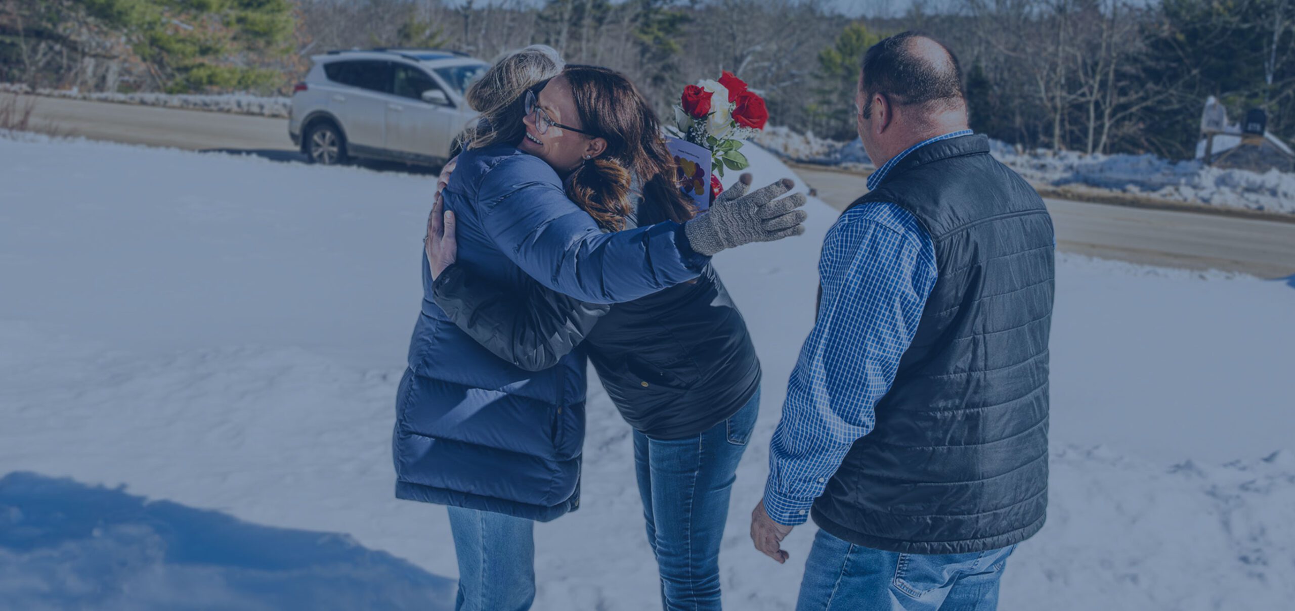 Kelsey Customer Service Representative and Rob Wilkes give flowers to Colby & Gale customer