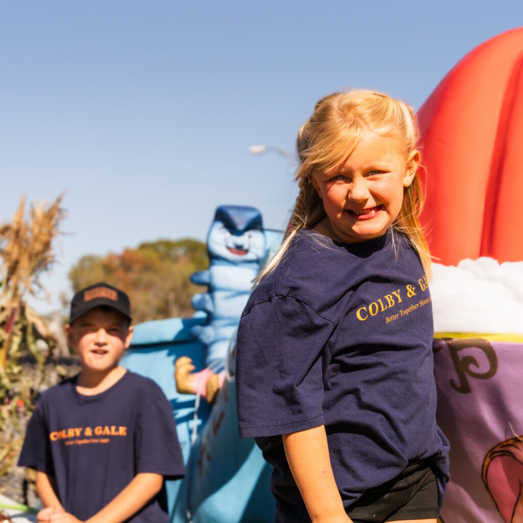 Little kids smiling for Pumpkinfest parade.