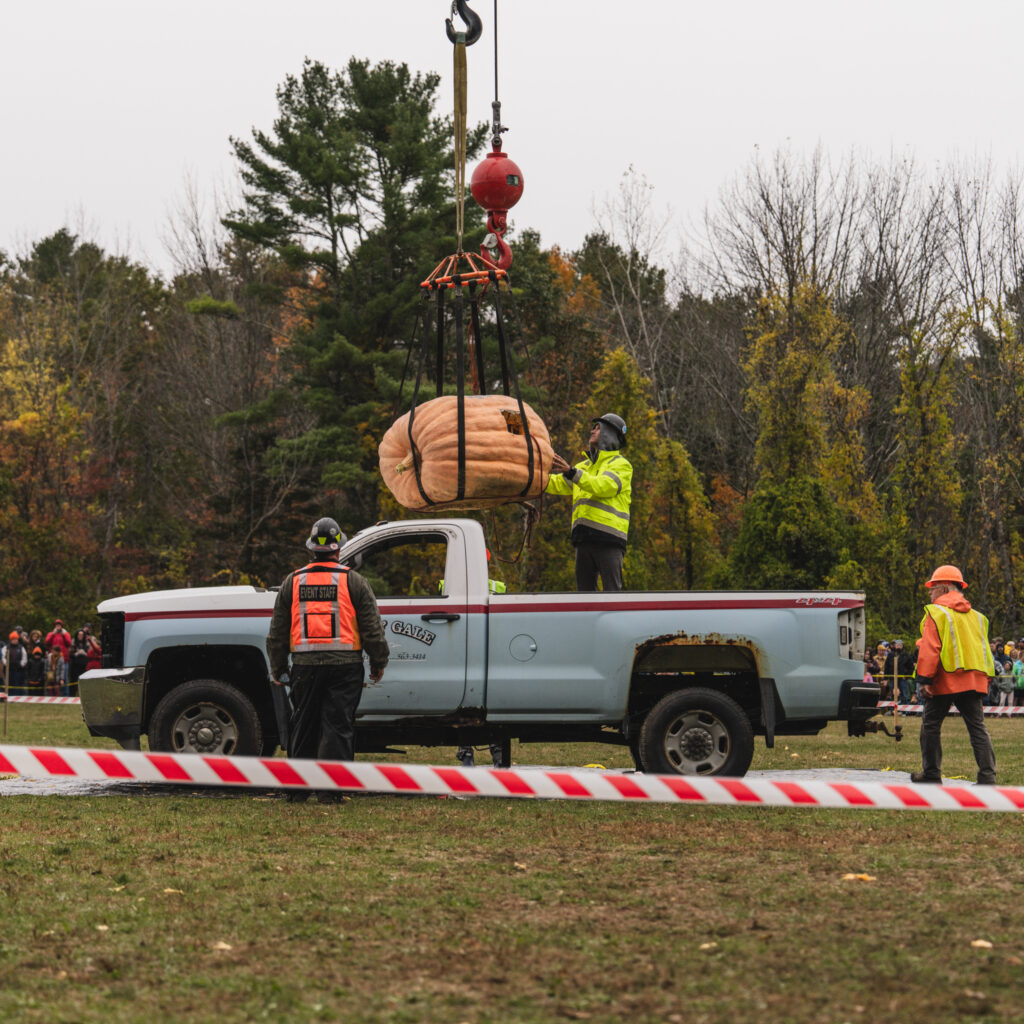 Pumpkinfest workers preparing the giant pumpkin to be dropped on Colby & Gale service truck. 