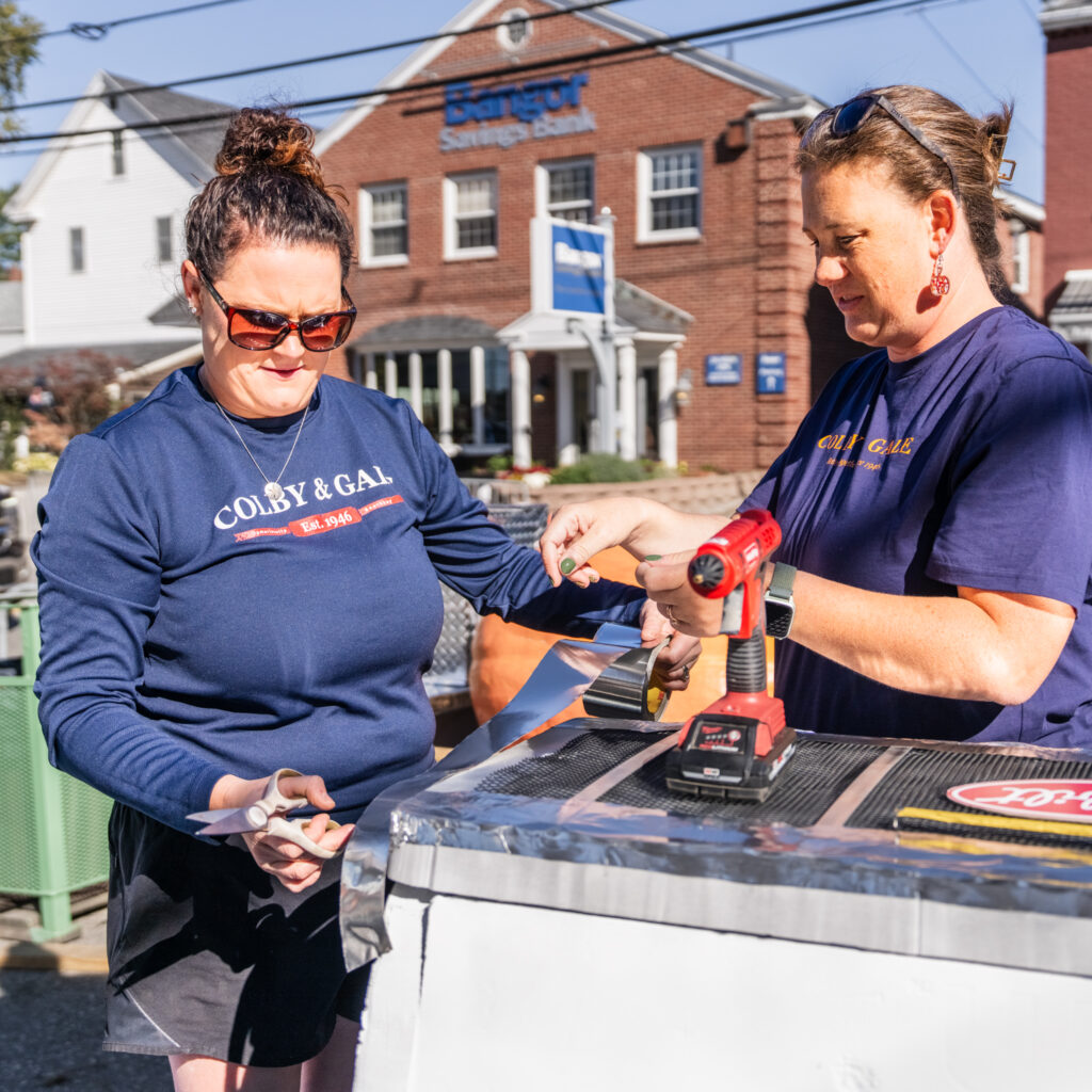Kelsey Cole and Kristen Dighton constructing the Colby & Gale pumpkin.