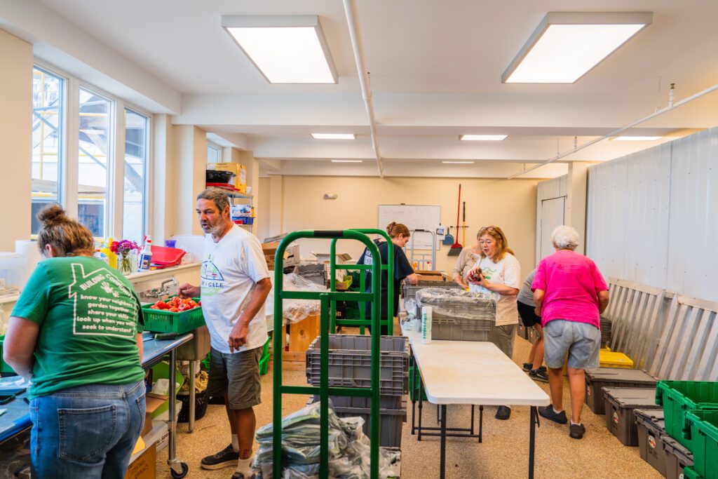 Orville Mooney and group of Twin Village Food pantry workers unloading donated produce.