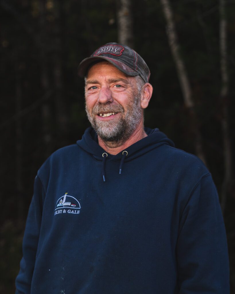 Jared Emry standing wearing a hat and Colby & Gale sweatshirt.