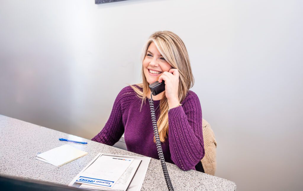 Leigh Benner a customer service representative answering the phone