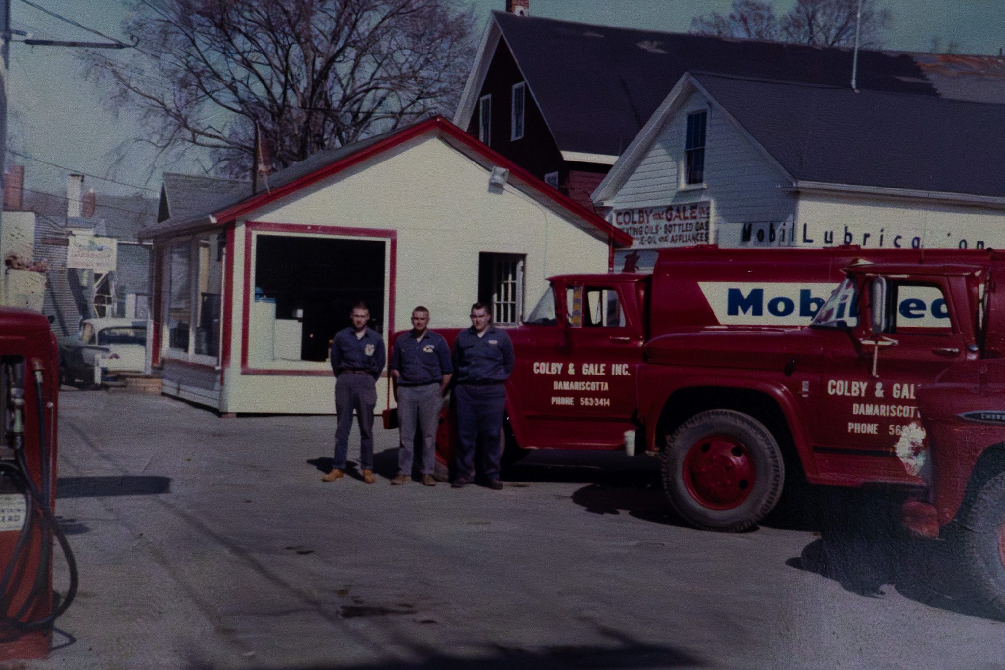 Neil Sprague and the Colby & Gale service team posing with the fuel delivery vehicle fleet at the company headquarters in Damariscotta, Maine.