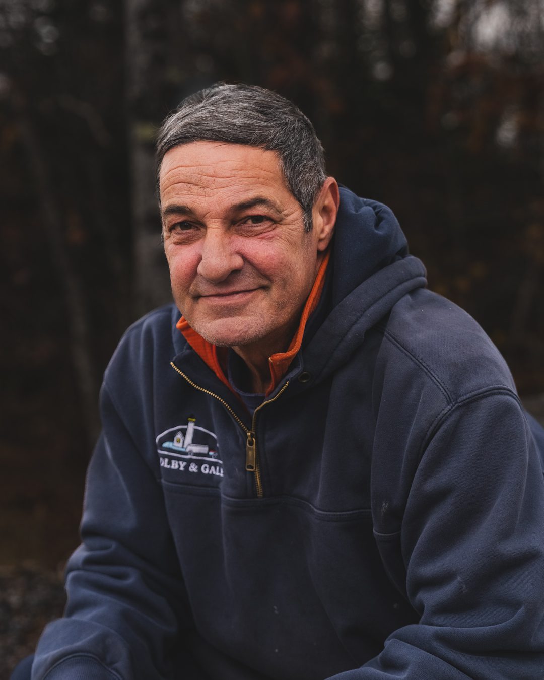 Orville Mooeny sitting and smiling at camera.