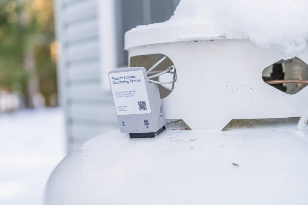 A Colby & Gale remote propane tank monitor installed on a residential tank during a Maine winter, ensuring reliable fuel tracking and automatic delivery in Damariscotta.