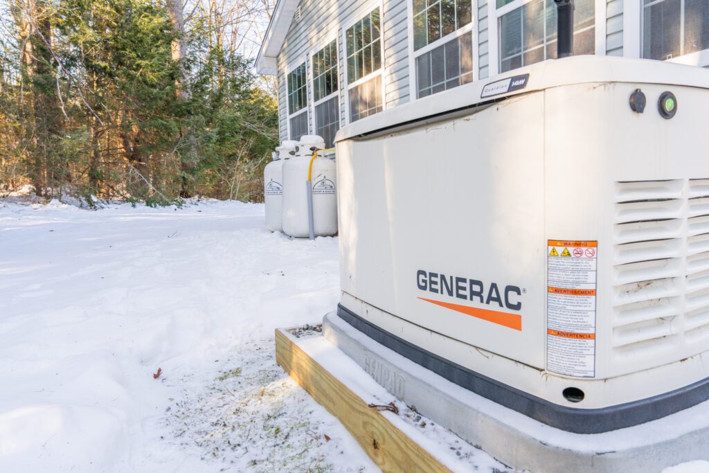 A Generac home standby generator connected to Colby & Gale propane tanks equipped with remote tank monitoring sensors in Damariscotta, Maine.