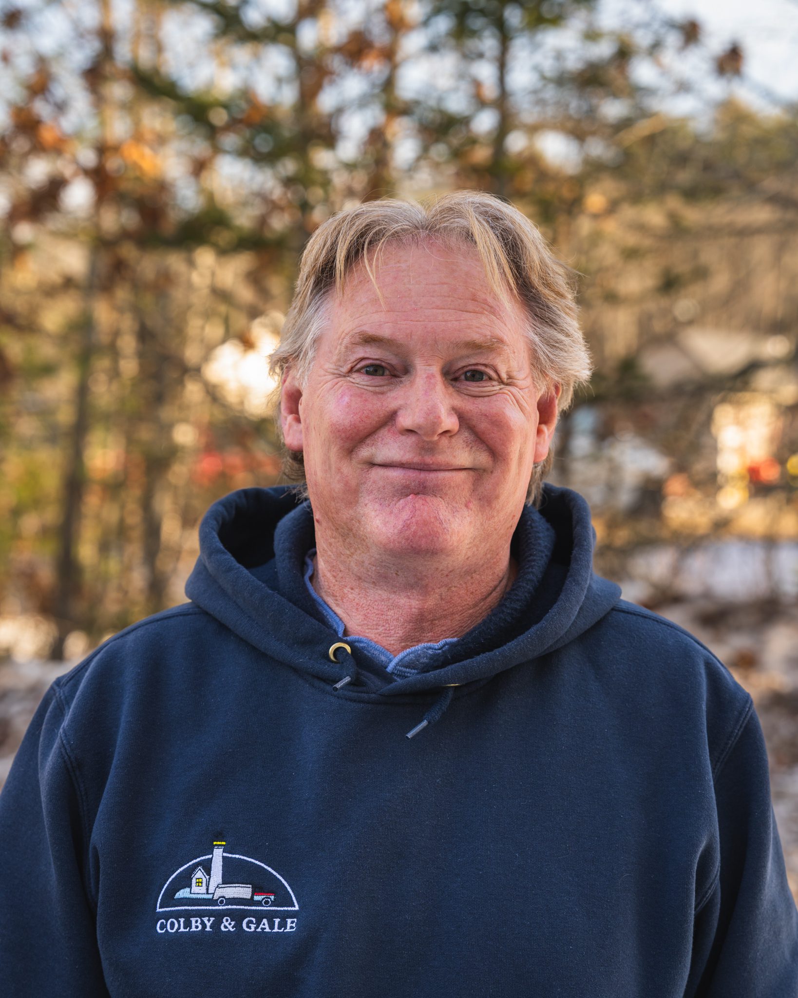 Sean Leeman, Energy Advisor wearing a Colby & Gale sweatshirt smiles at the camera.