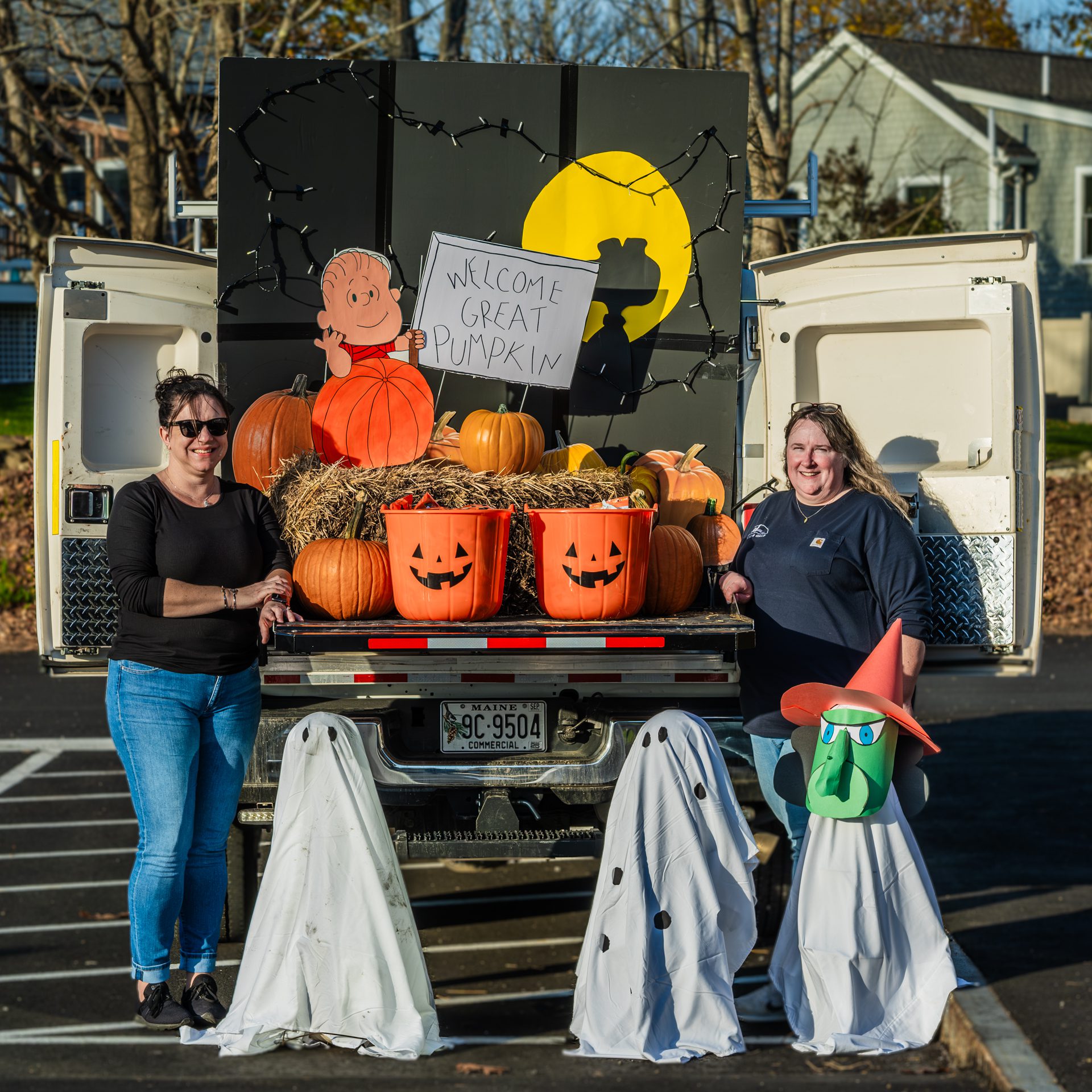 Amanda Reed and Kerri Lincoln in front of trunk or treat decorations.