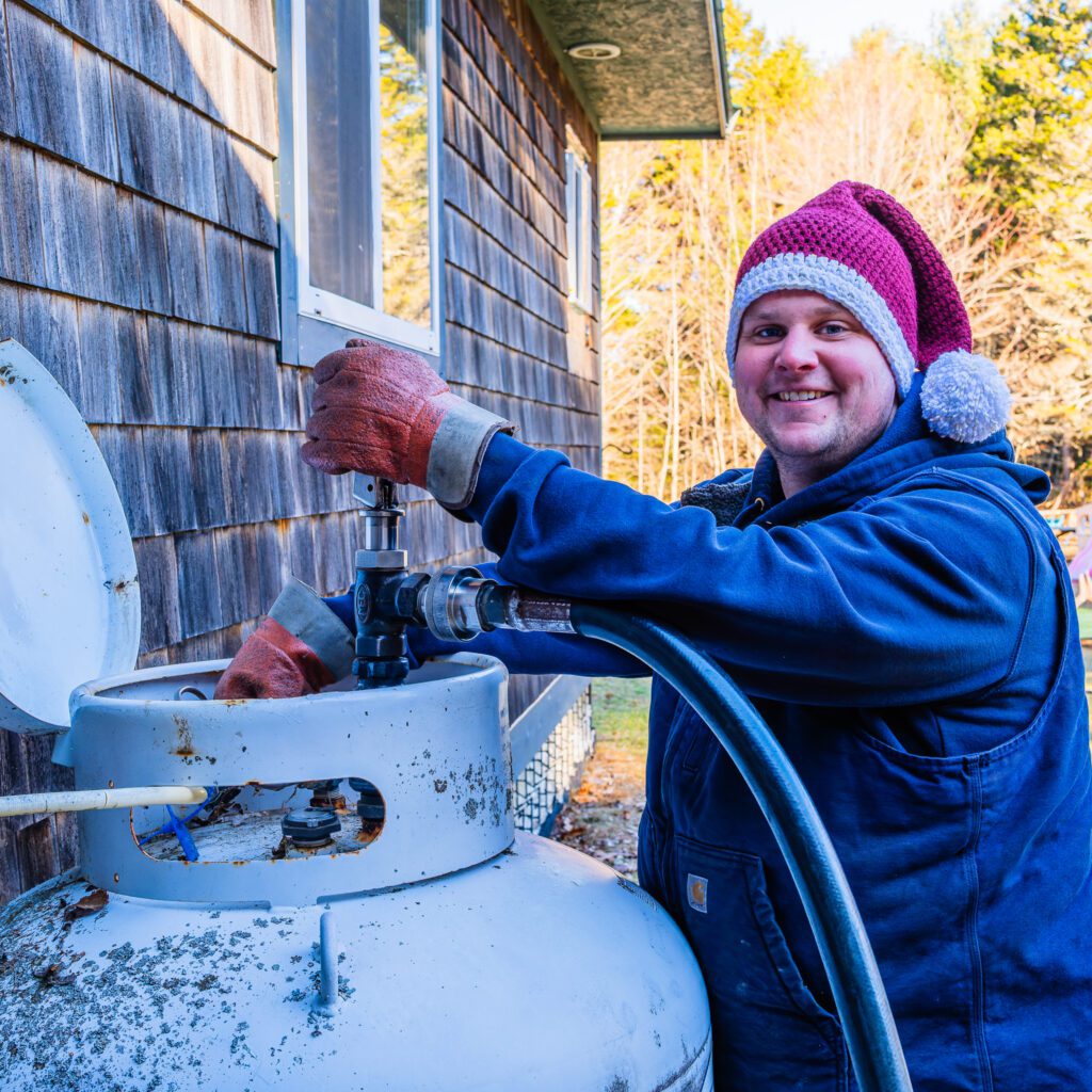 Nick Greenleaf filling up propane tank.