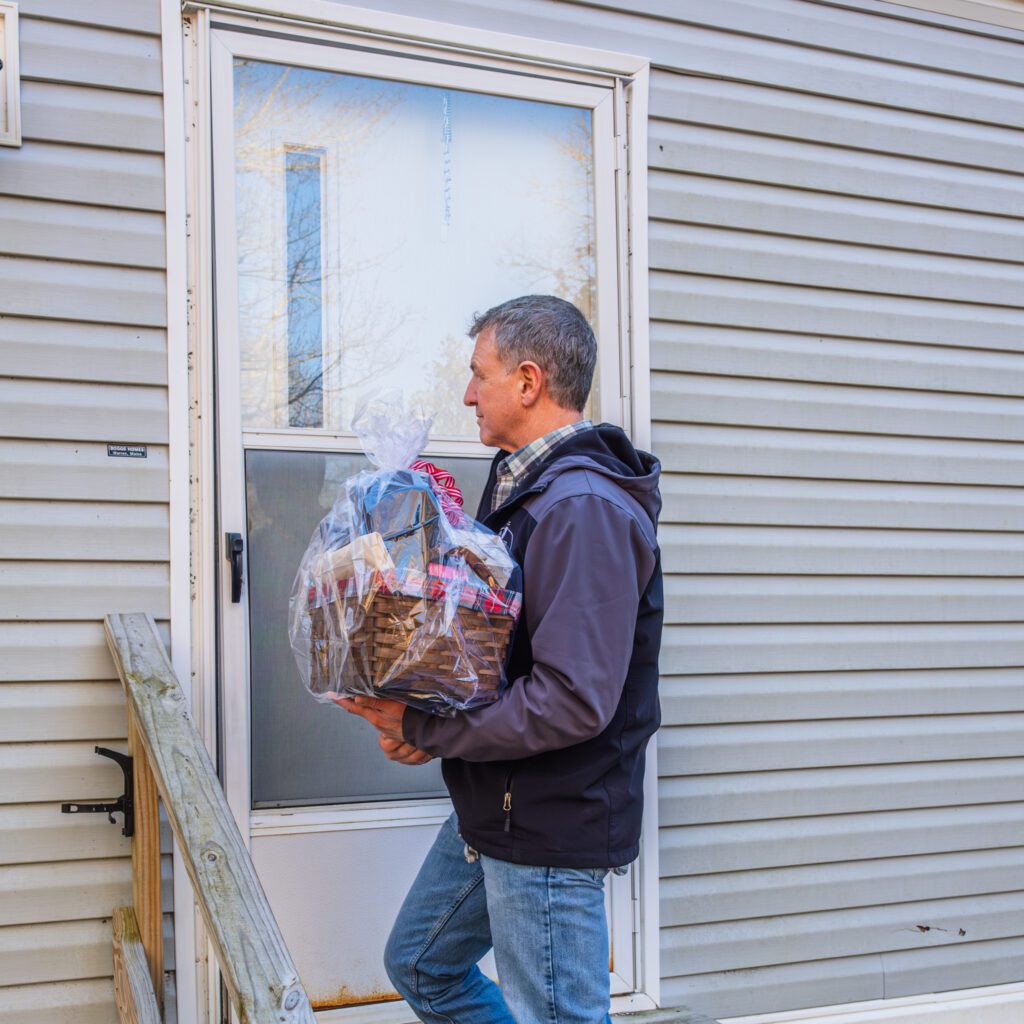 Cappy Dean delivering 12 days of Christmas package to customers in need,