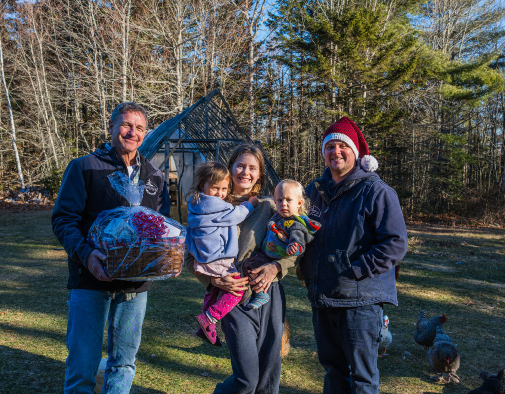 Cappy and Nick posing with customer and her kids outside. 